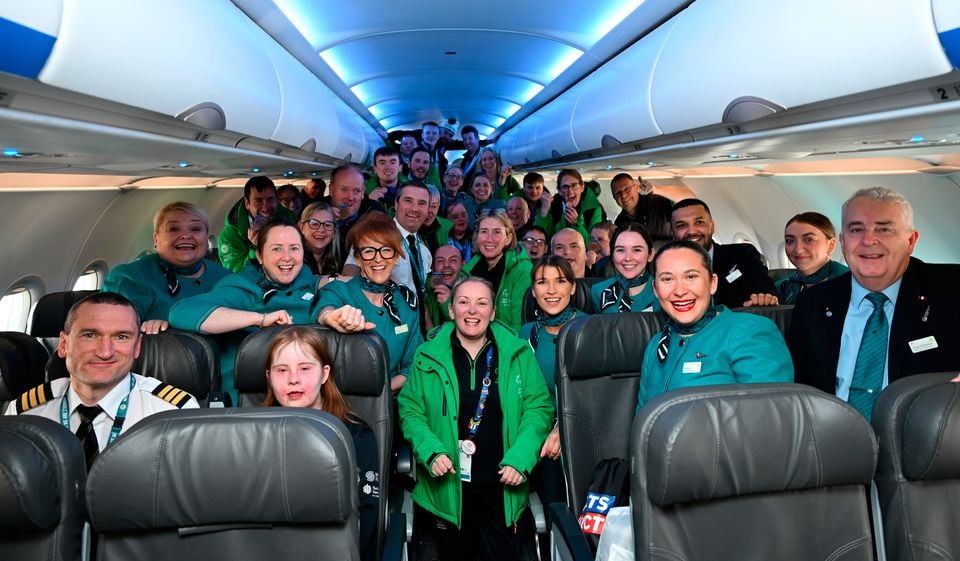 16 March 2025; Captain Ray Kelly, First officer, Robert Maguire, Sinéad Costello, Head of Delegation, Tony Kinnane, Senior cabin crew member, athletes and coaches with Aer Lingus staff on arrival at Dublin airport after competing in the Turin 2025 Special Olympics World Winter Games in Italy. Photo by Ray McManus/Sportsfile 