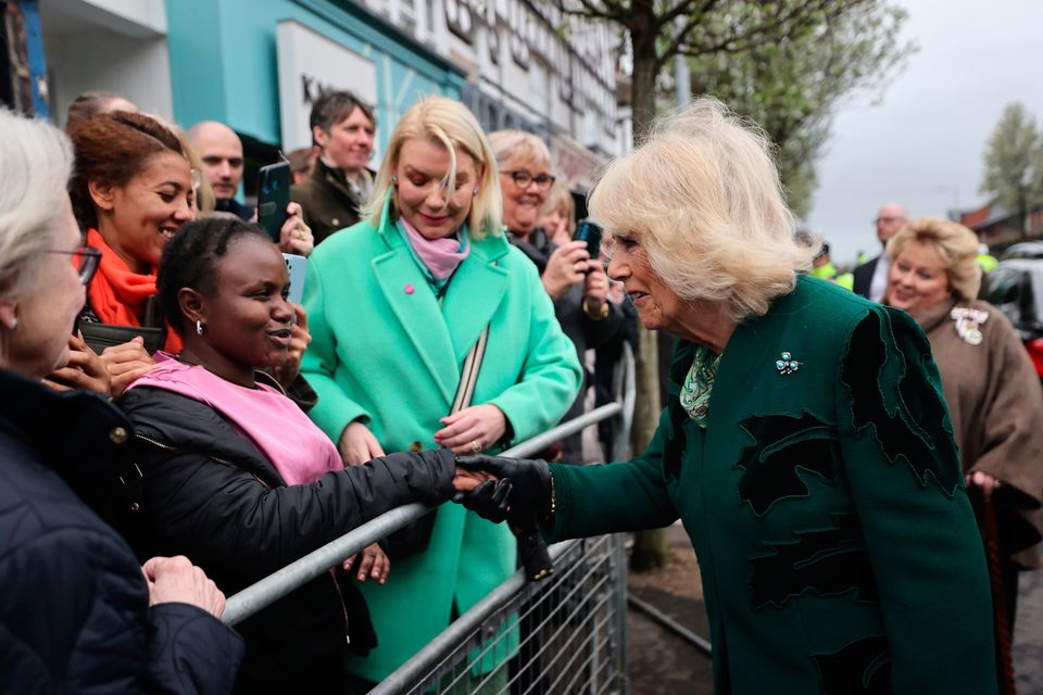 Queen Camilla meets members of the public during a visit to Lisburn Road in Belfast to meet shop owners and staff. Image: Liam McBurney/PA Wire