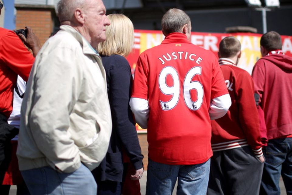 A young Liverpool fan with Justice 96 on the back of his shirt