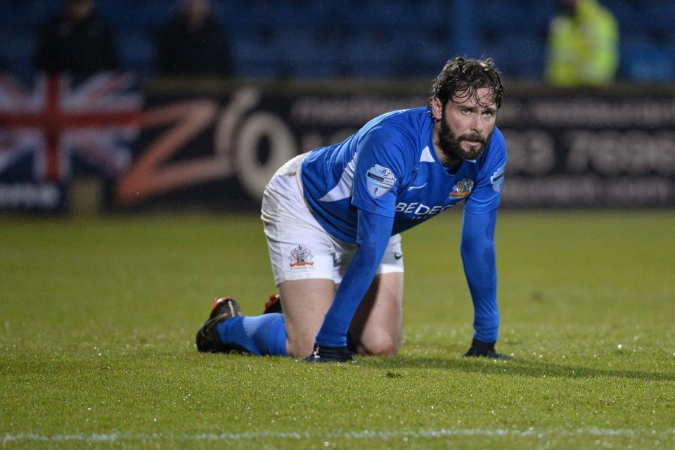 Kneesy does it: Gary Hamilton takes a well-deserved
breather in last Friday’s game with Linfield