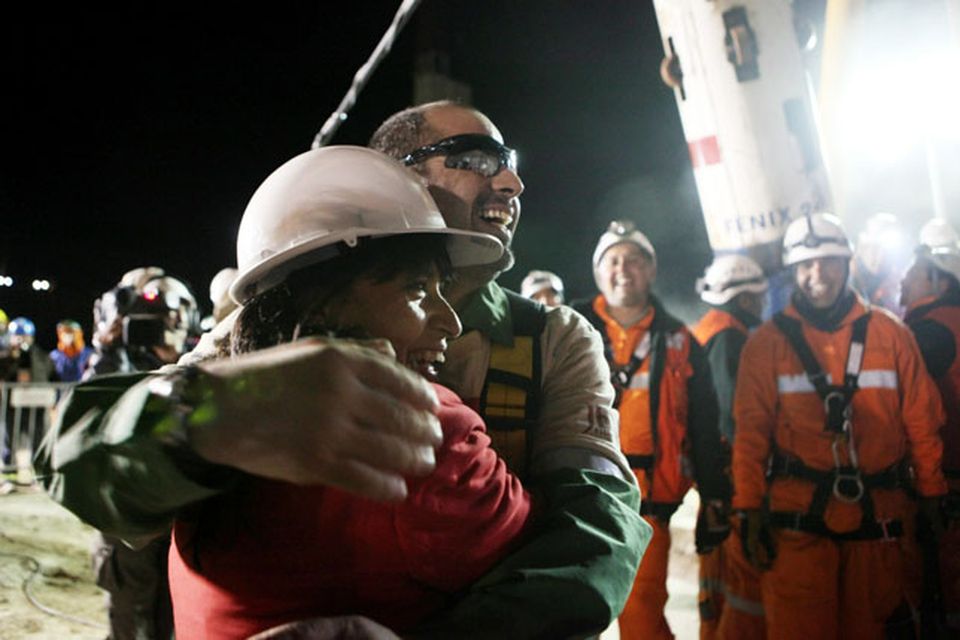 SAN JOSE MINE, CHILE - OCTOBER 12: (NO SALES, NO ARCHIVE) In this handout from the Chilean government, Mario Sepulveda, 39, the second miner to exit the rescue capsule, receives a hug October 12, 2010 at the San Jose mine near Copiapo, Chile. The rescue operation has begun bringing up the 33 miners, 69 days after the August 5th collapse that trapped them half a mile underground. (Photo by Hugo Infante/Chilean Government via Getty Images)