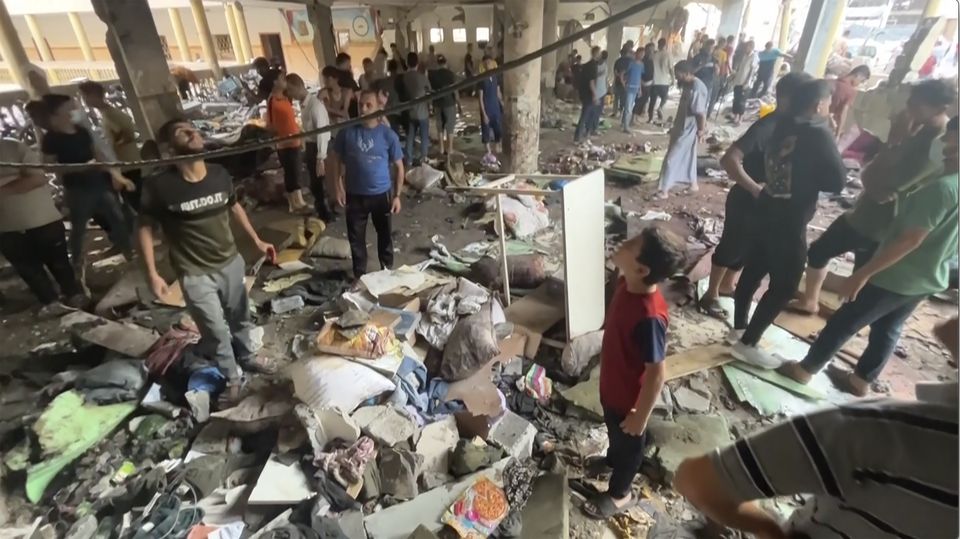 People inspect the dome at a school hit by an Israeli air strike in Gaza City Saturday (AP)