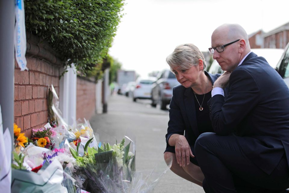 Home Secretary Yvette Cooper and Patrick Hurley, the Labour MP for Southport, look at tributes laid near to the knife attack that left three children dead (James Speakman/PA)