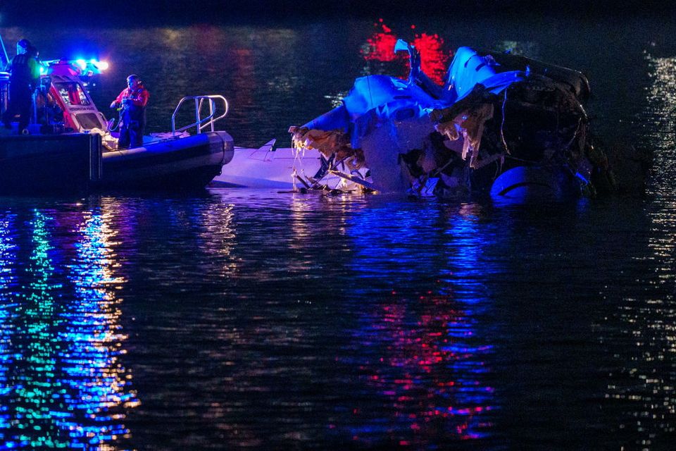 Emergency response teams including Washington, DC Fire and EMS, DC Police and others, assess the airplane wreckage in the Potomac River (Photo by Andrew Harnik/Getty Images)