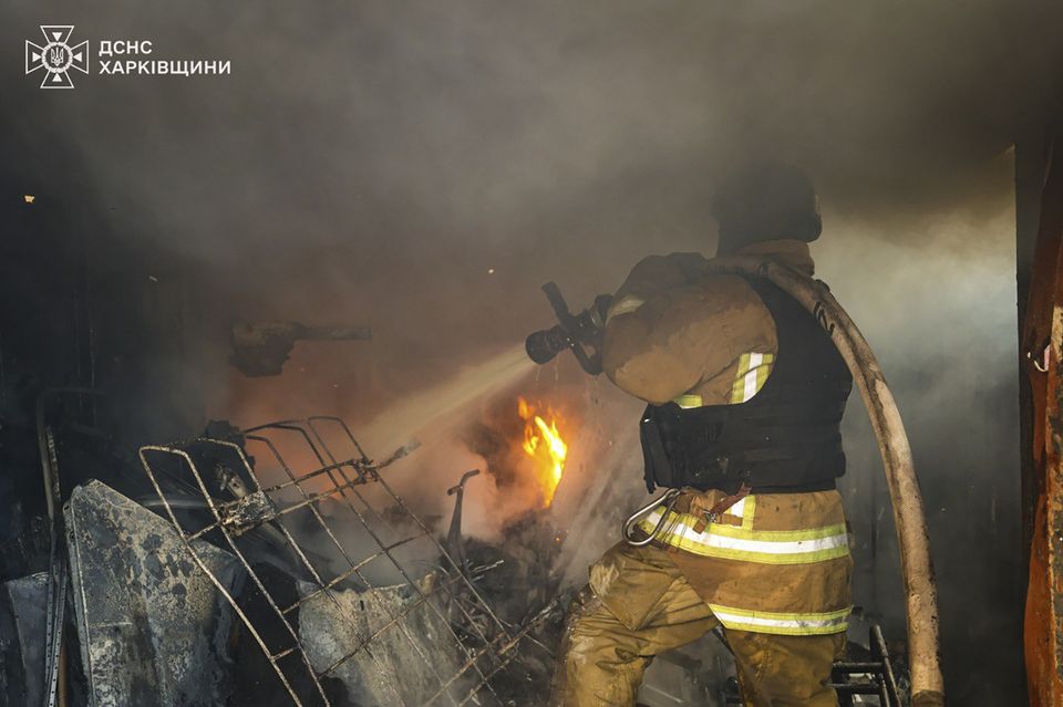 A firefighter works to extinguish a blaze following a Russian rocket attack in Kharkiv, Ukraine (Ukrainian Emergency Service via AP)