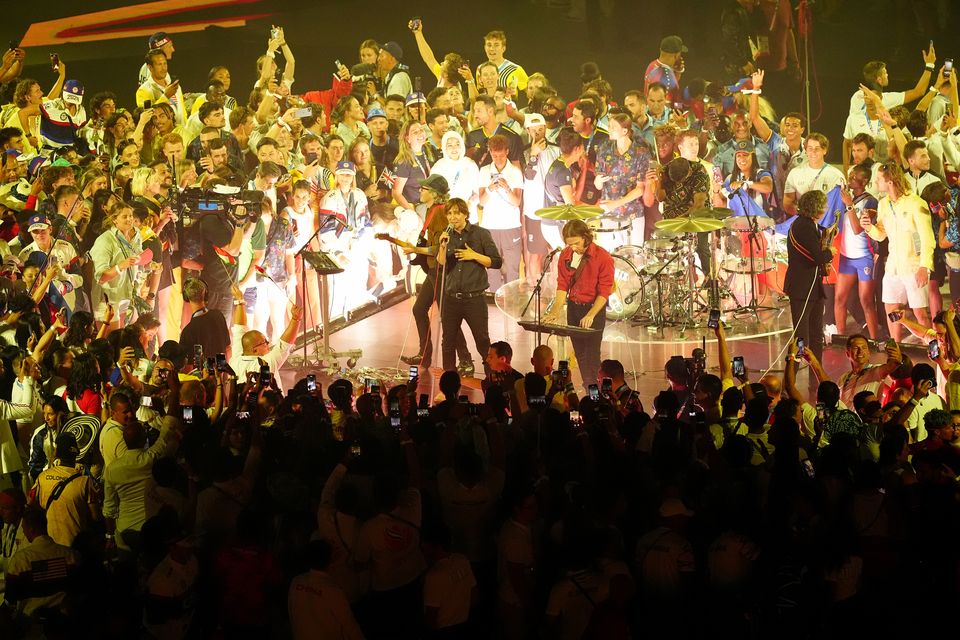 Athletes invade the stage as Phoenix perform during the closing ceremony (David Davies/PA)