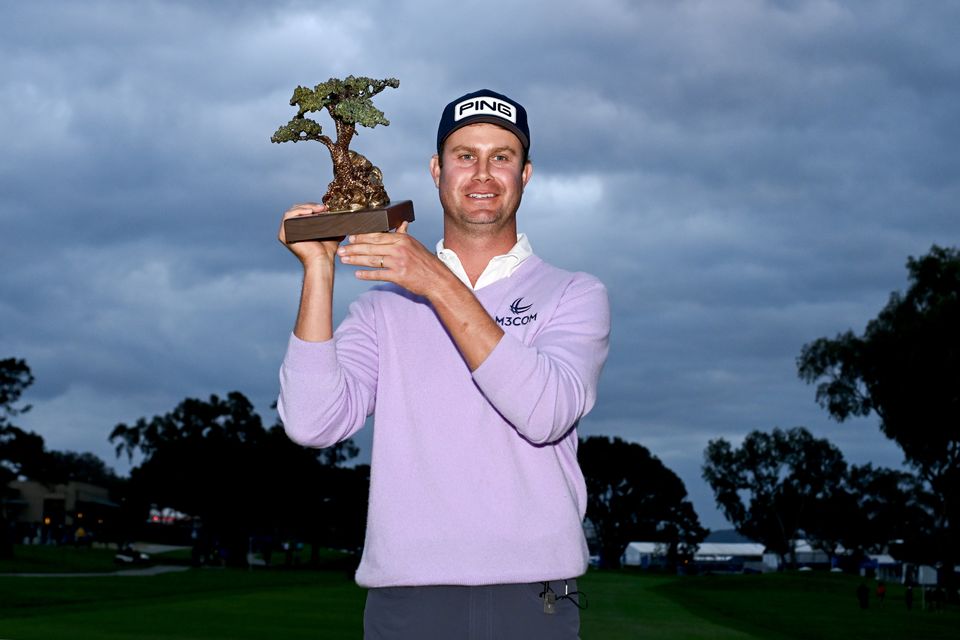 Harris English poses with the trophy after winning the Farmers Insurance Open at Torrey Pines