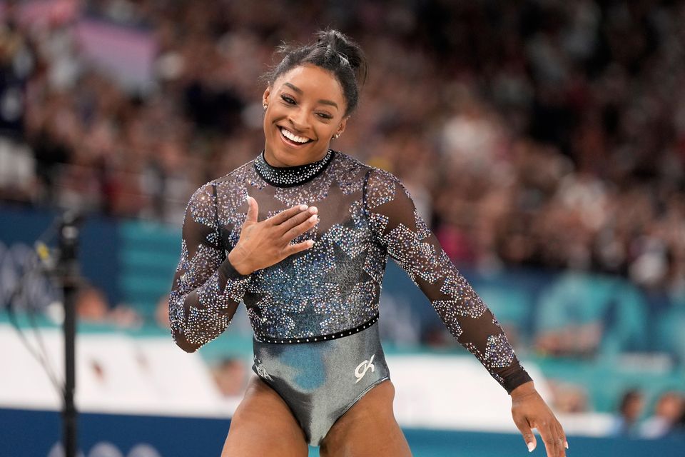 Simone Biles competes on the balance beam during the women’s artistic gymnastics qualification round at the Bercy Arena in Paris (Abbie Parr/AP)