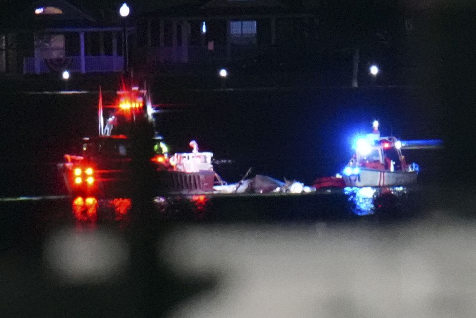 Boats work the scene on the Potomac River near Ronald Reagan Washington National Airport (Julio Cortez/AP)