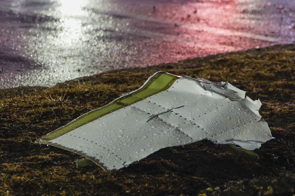 Debris in a parking lot after the small plane crashed (Steven M Falk/The Philadelphia Inquirer via AP)