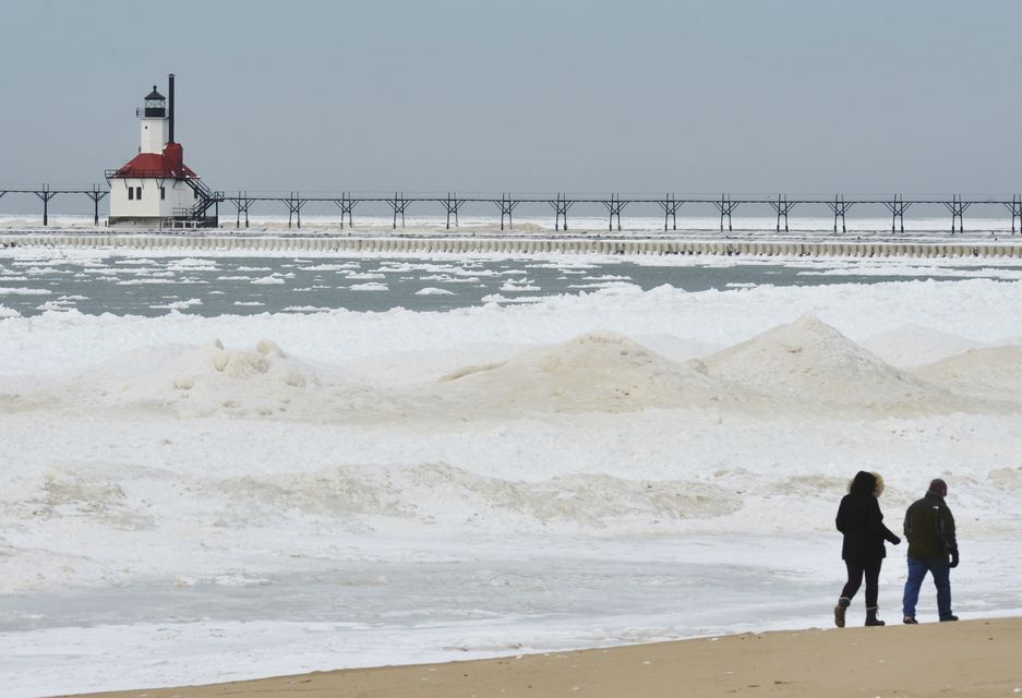 Ice builds up along the Lake Michigan shoreline in St Joseph, Michigan (Don Campbell/The Herald-Palladium/AP)