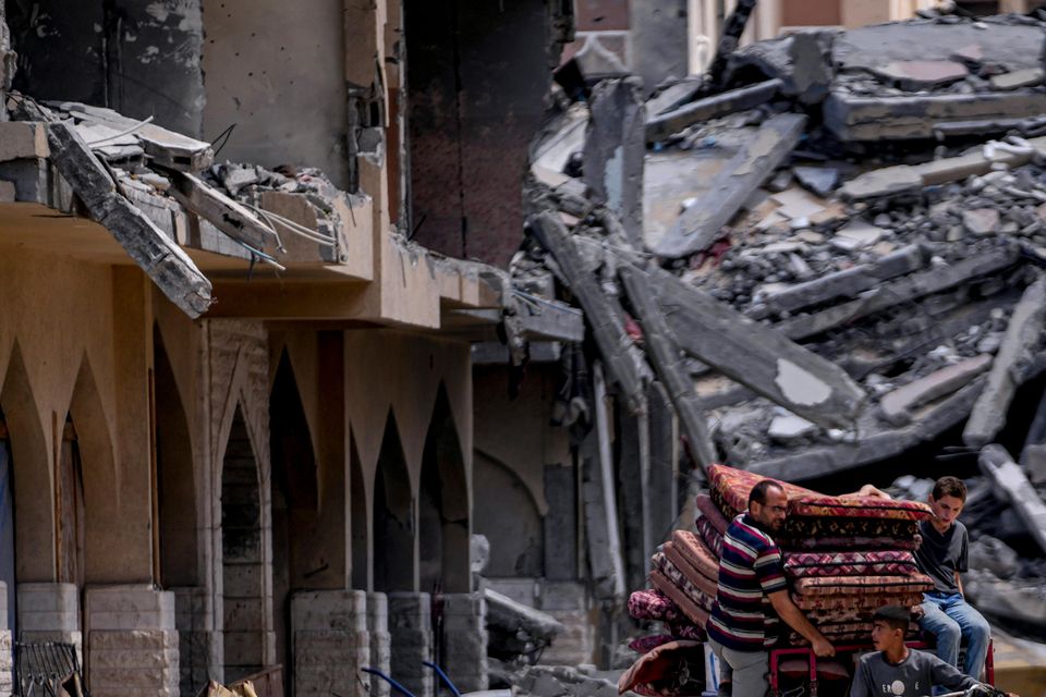 Palestinians leave with what they can carry (Abdel Kareem Hana/AP)