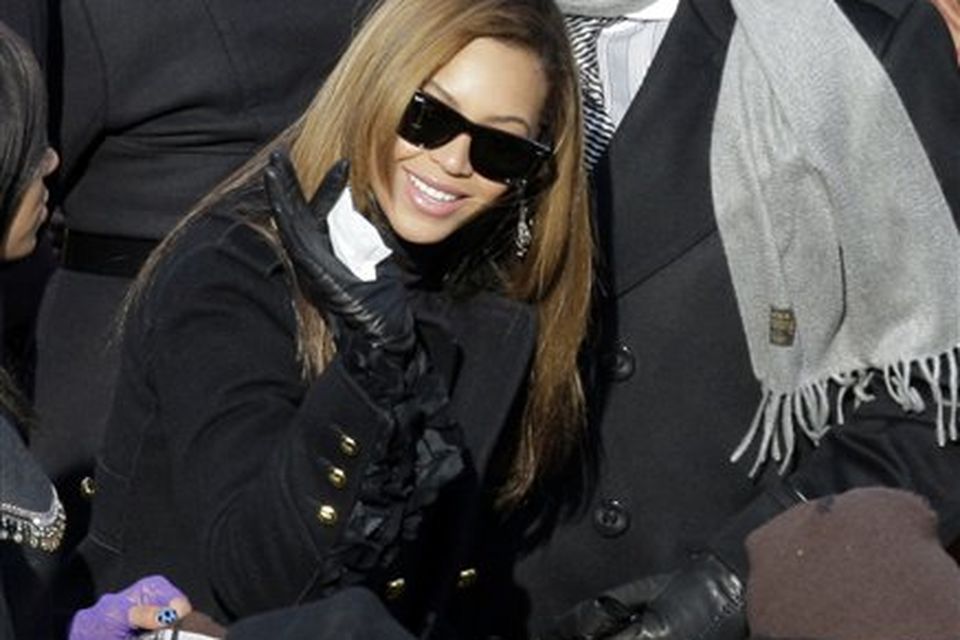 Jay-Z and Beyonce try to find their seats as they arrive for the inauguration ceremony at the U.S. Capitol in Washington, Tuesday, Jan. 20, 2009.  (AP Photo/Jae C. Hong)