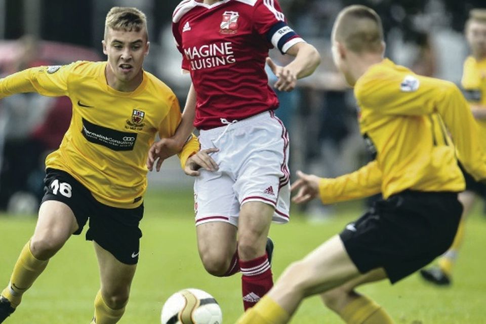 Outnumbered: Antrim's Jack McCourt and Dylan Davidson close in on Swindon's Mason Hathaway