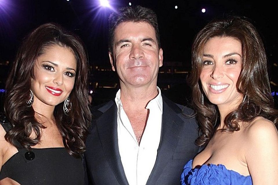 Simon Cowell with UK X Factor judge Cheryl Cole, left, and his fiancee Mezhgan Hussainy