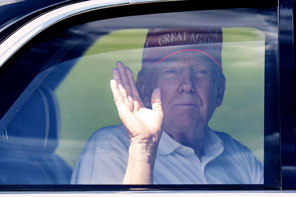 President Donald Trump waves from his limousine as he leaves Trump International Golf Club on Saturday in West Palm Beach (Manuel Balce Ceneta/AP)