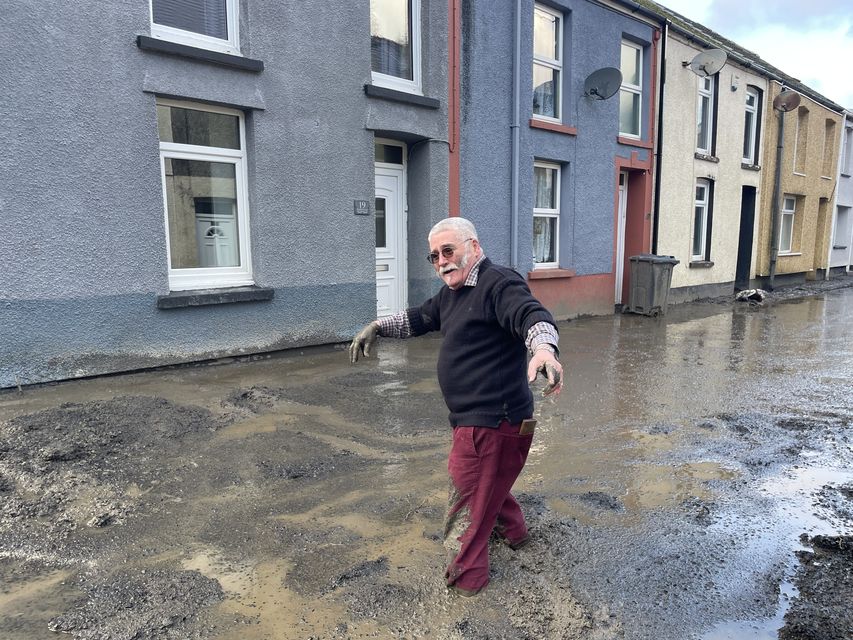 Rob Scholes, 75, walking through floodwater and mud after a landslip forced people from their homes in Cwmtillery during Storm Bert in November (George Thompson/PA)