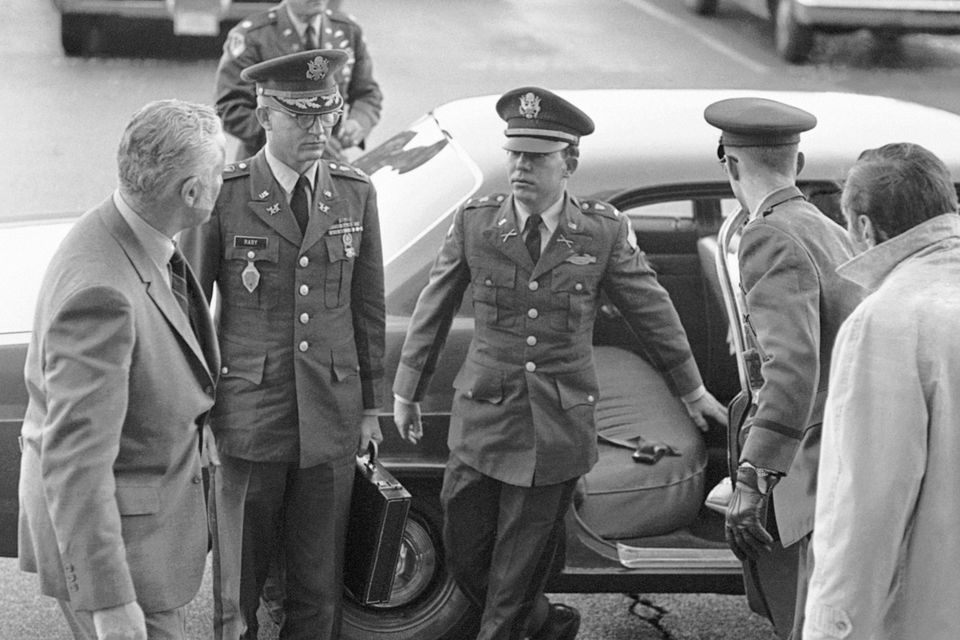 Lt William L Calley Jr, centre, and his military counsel, arrive the Pentagon for testimony before an Army board of investigation in 1969 (AP Photo/File)