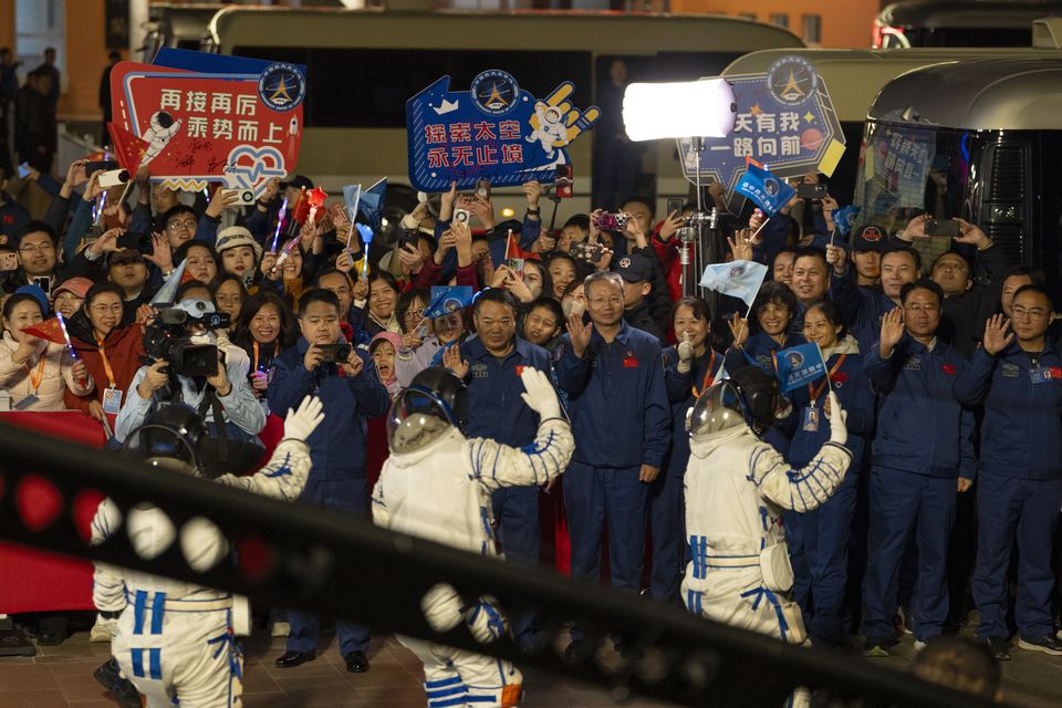 Chinese astronauts Wang Haoze, from left, Song Lingdong and Cai Xuzhe wave during the see-off ceremony for the Shenzhou-19 mission at the Jiuquan Satellite Launch Centre in northwestern China (Ng Han Guan/AP)