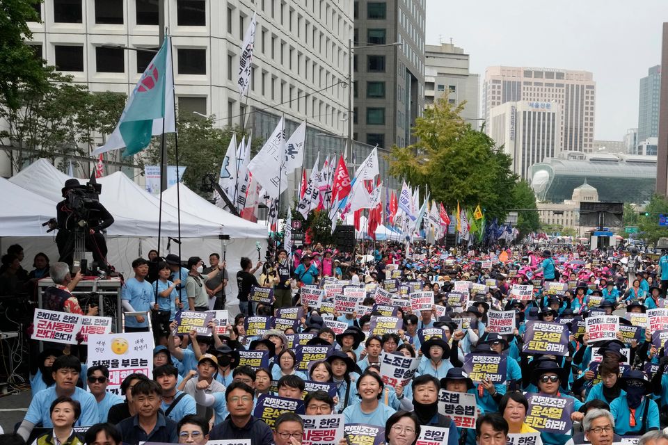 South Korean protesters stage a rally opposing the joint military exercises between the US and South Korea in Seoul on Saturday (Ahn Young-Joon/AP)