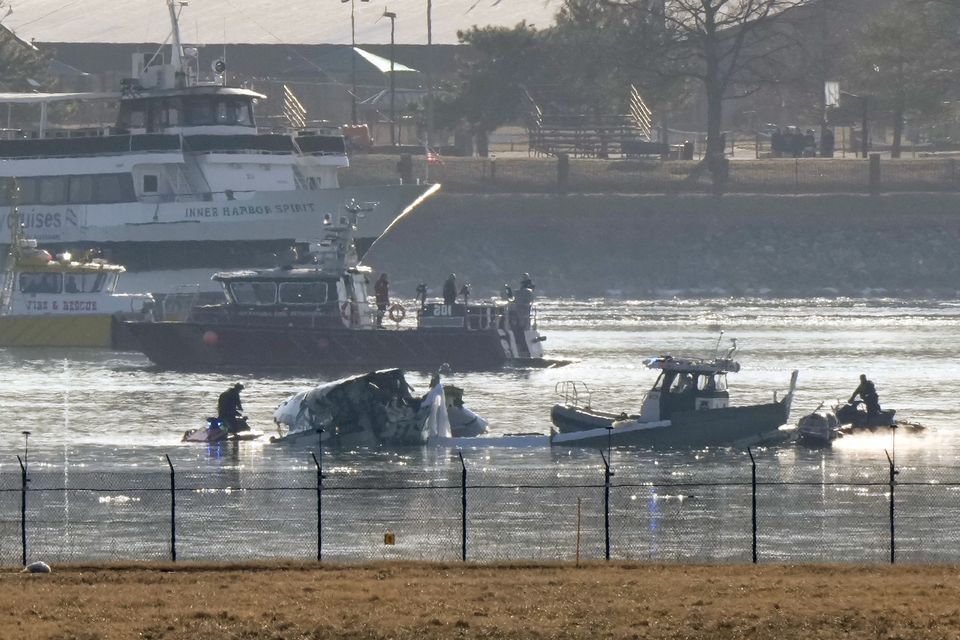 Search and rescue efforts are seen around the wreckage site in the Potomac river near Ronald Reagan Washington National Airport (AP Photo/Mark Schiefelbein)