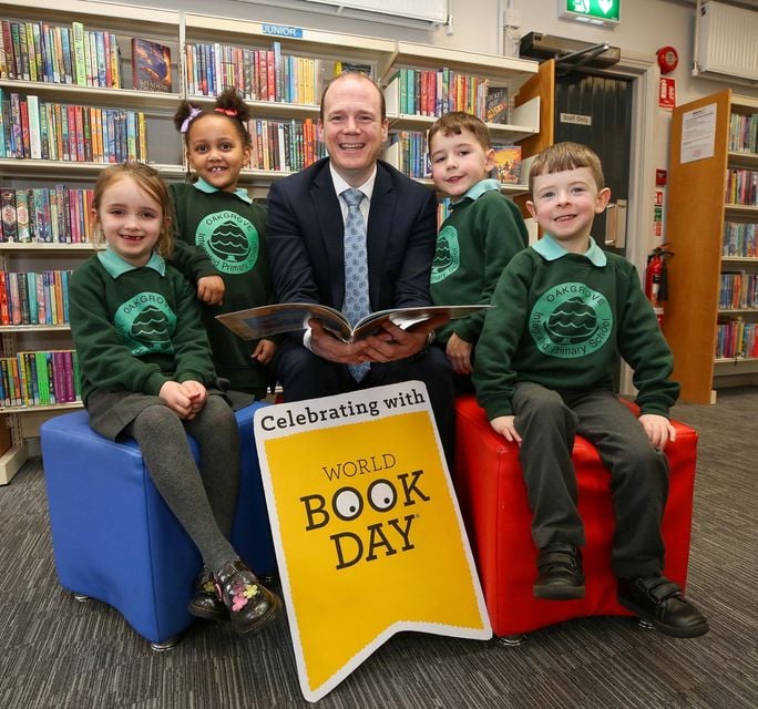 Communities Minister Gordon Lyons celebrates World Book Day with Oakgrove Integrated Primary School during a visit to Waterside Library