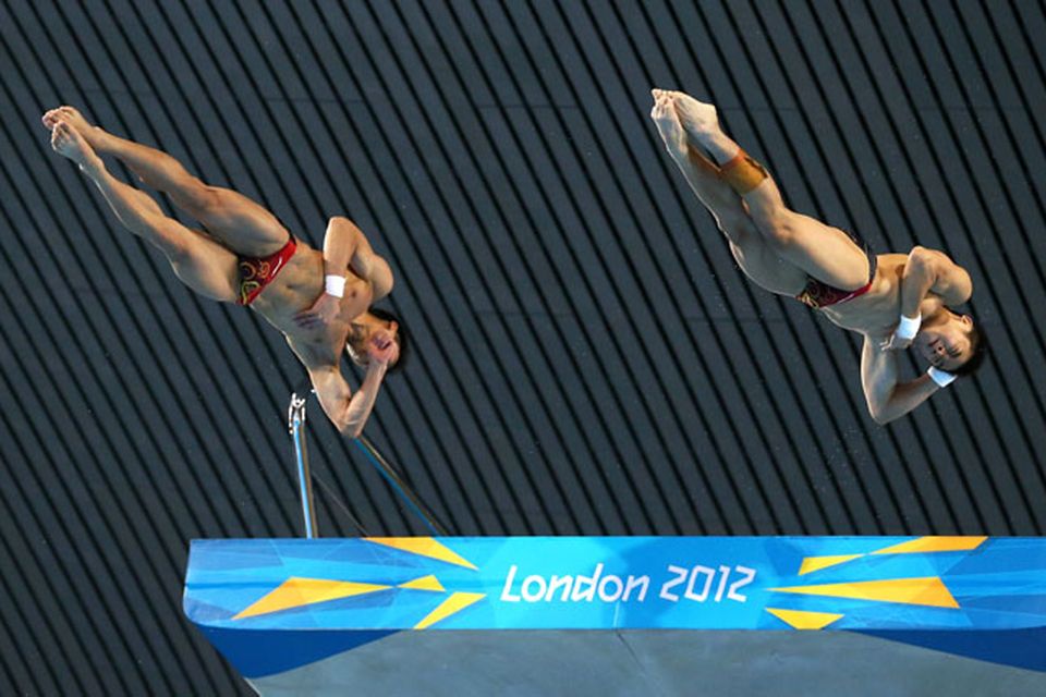LONDON, ENGLAND - JULY 30:  Yuan Cao and Yanquan Zhang of China compete in the Men's Synchronised 10m Platform Diving on Day 3 of the London 2012 Olympic Games at the Aquatics Centre on July 30, 2012 in London, England.  (Photo by Al Bello/Getty Images)