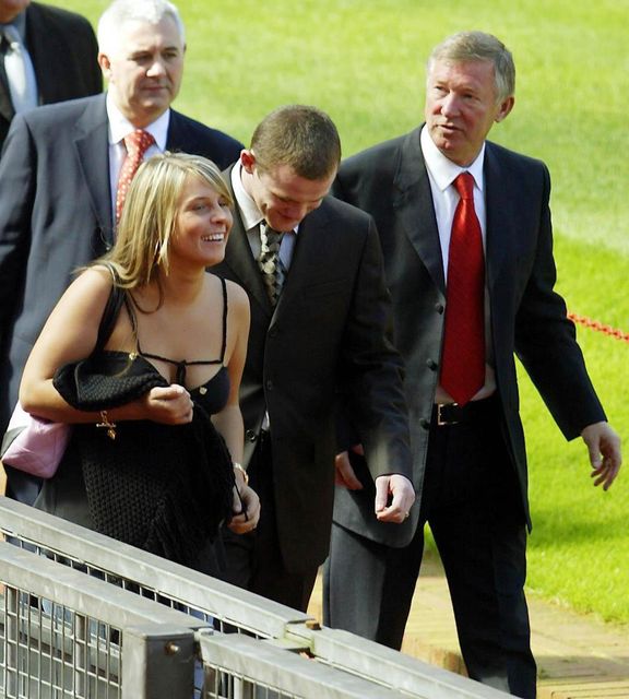 Wayne Rooney with girlfriend Coleen and Manchester United’s manager Sir Alex Ferguson in 2004 (Gareth Copley/PA)