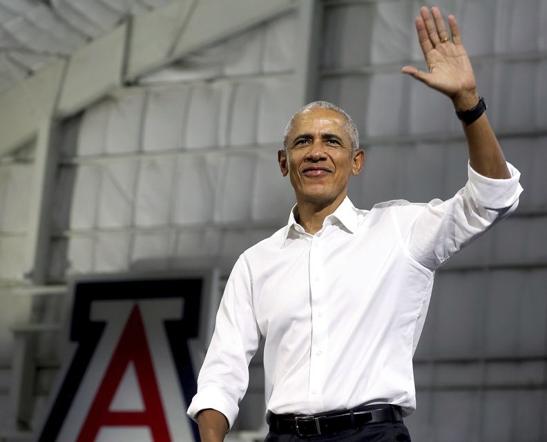 Former President Barack Obama held an early voting rally alongside vice presidential nominee Tim Walz (Mamta Popat/Arizona Daily Star via AP)