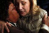 thumbnail: Chile's First Lady Cecilia Morel, right, embraces a relative of a trapped miner outside the San Jose mine in Copiapo, Chile (AP)