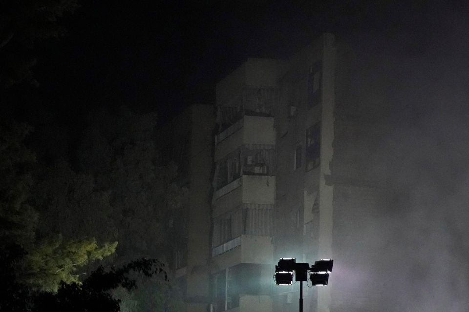 Rescuers at the site of an Israeli air strike in Beirut’s southern suburbs (Hassan Ammar/AP)