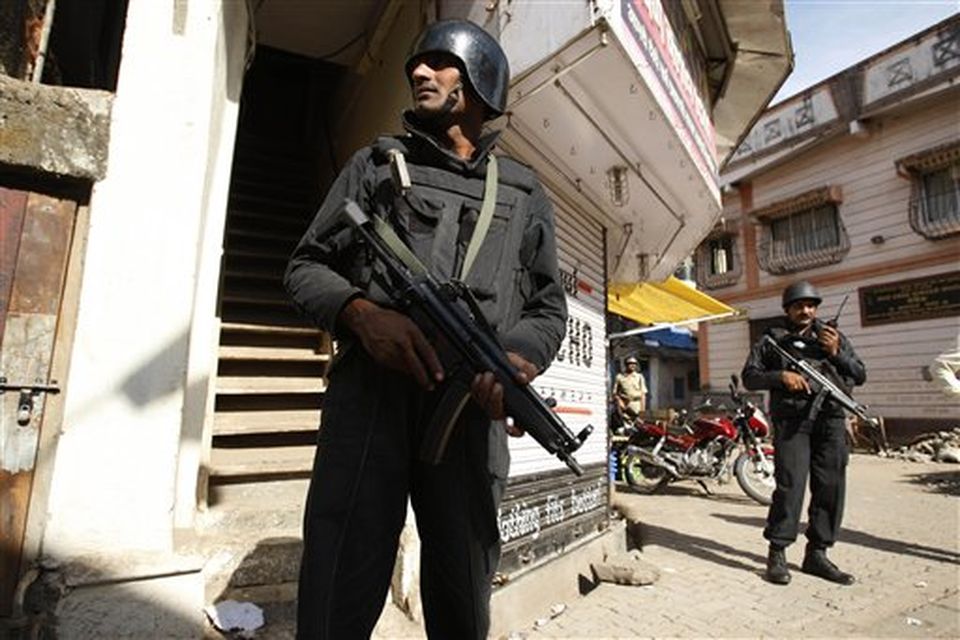 National Security Guard commandoes secure an area near an apartment where suspected gunmen have held a family hostage in Colaba, Mumbai, India, Thursday, Nov. 27, 2008. Teams of gunmen stormed luxury hotels, a popular restaurant, hospitals and a crowded train station in coordinated attacks across India's financial capital, killing at least 101 people, taking Westerners hostage and leaving parts of the city under siege Thursday, police said. A group of suspected Muslim militants claimed responsibility. (AP Photo/Saurabh Das)