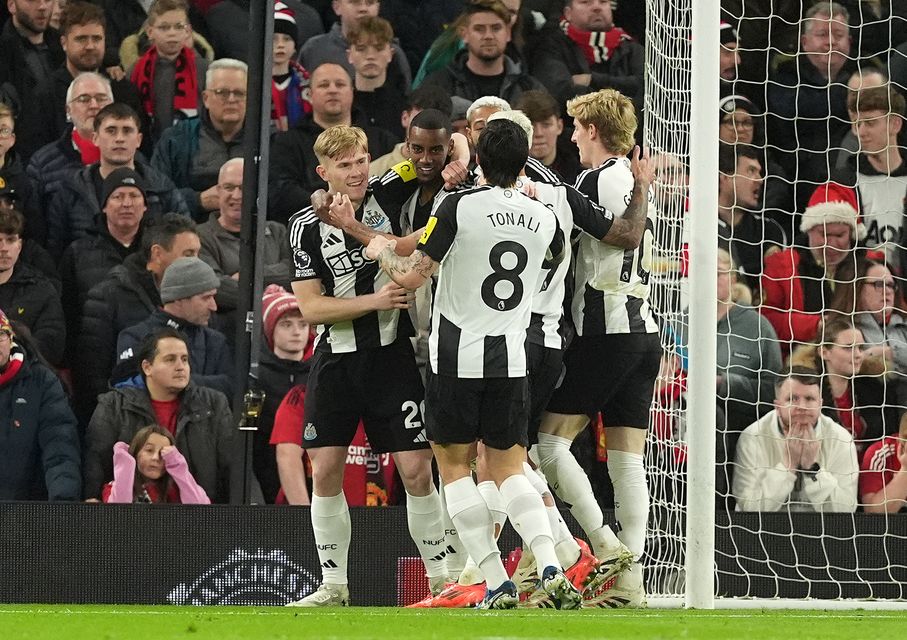 Newcastle’s Alexander Isak is surrounded by team-mates after scoring the winner at Tottenham (PA)