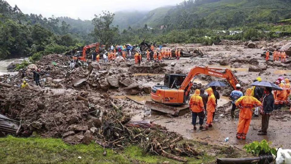 This photograph provided by the National Disaster Response Force (NDRF) shows rescuers at a spot after a landslide (NDRF via AP)