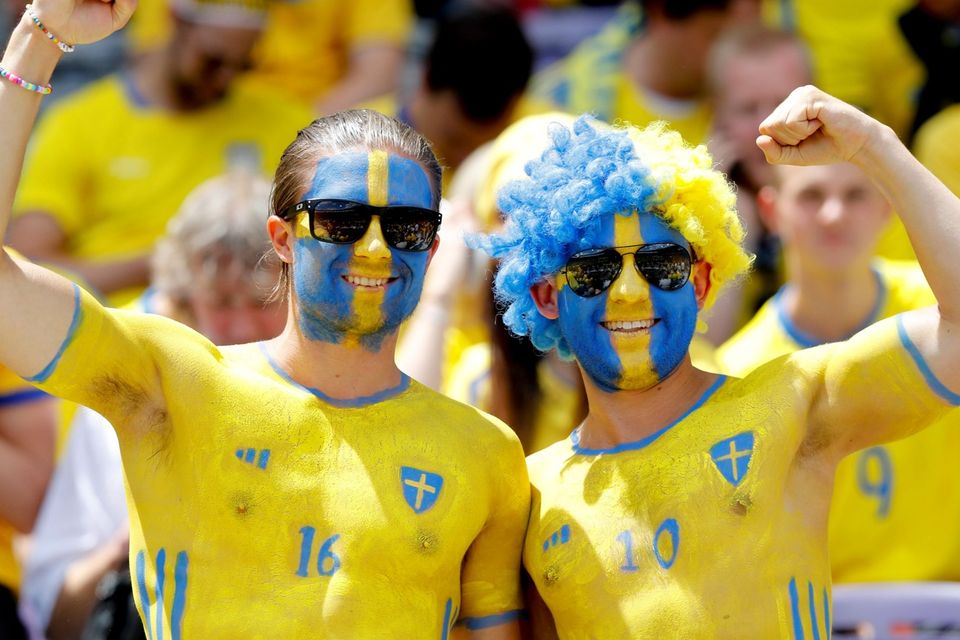 The beautiful game - football fans from around the world. Swedish supporters, their faces painted in the colors of the national flag, cheer as they wait for the start of the Euro 2016 Group E soccer match between Italy and Sweden at the Stadium municipal in Toulouse, France, Friday, June 17, 2016. (AP Photo/Antonio Calanni)