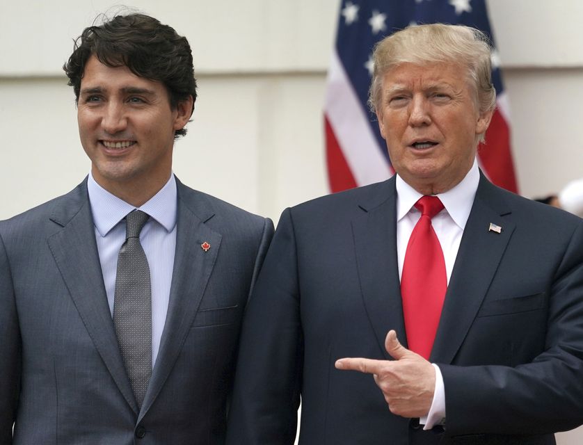 Donald Trump and Justin Trudeau pose for a photo as Trudeau arrives at the White House in Washington (Carolyn Kaster/AP)