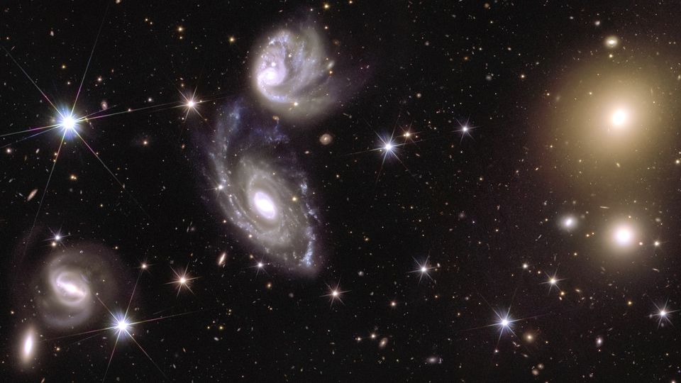 Left, two galaxies, called ESO 364-G035 and G036, that are interacting with each other 420 million light-years away and right, galaxy cluster Abell 3381, 678 million light-years away, captured by the Euclid telescope (ESA/Euclid/Euclid Consortium/NASA/CEA Paris-Saclay/JC Cuillandre/E Bertin/G Anselmi/PA)