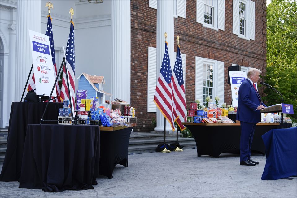 With consumer goods placed on tables near him, Republican presidential nominee Donald Trump speaks at a news conference (Julia Nikhinson/AP)