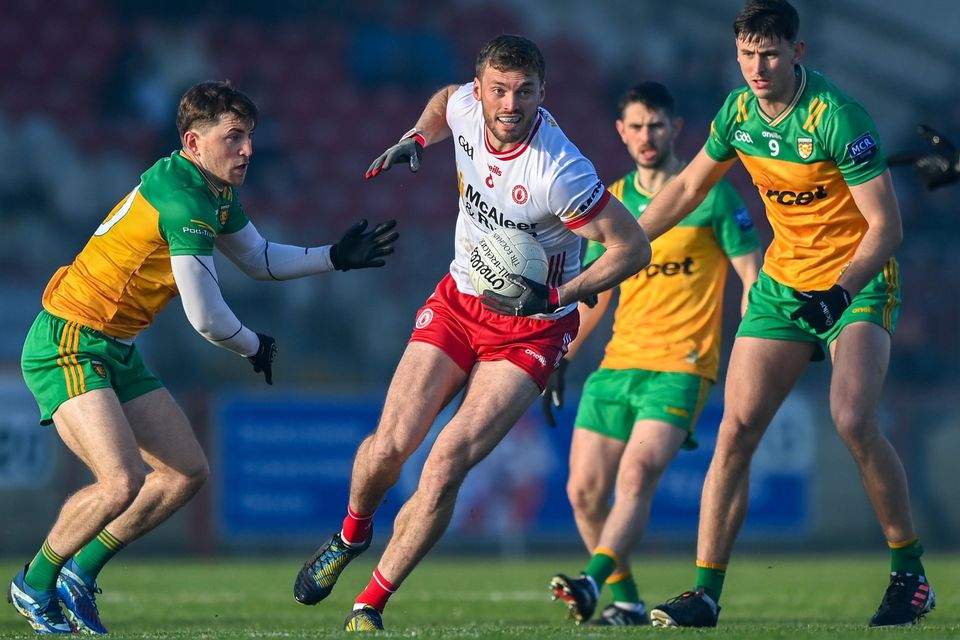 Brian Kennedy of Tyrone in action against Shane O'Donnell (left) and Michael Langan of Donegal during this year's McKenna Cup clash