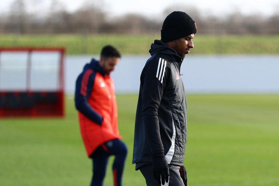 Manchester United's Marcus Rashford during training at Carrington, with manager Rubin Amorim in the background.