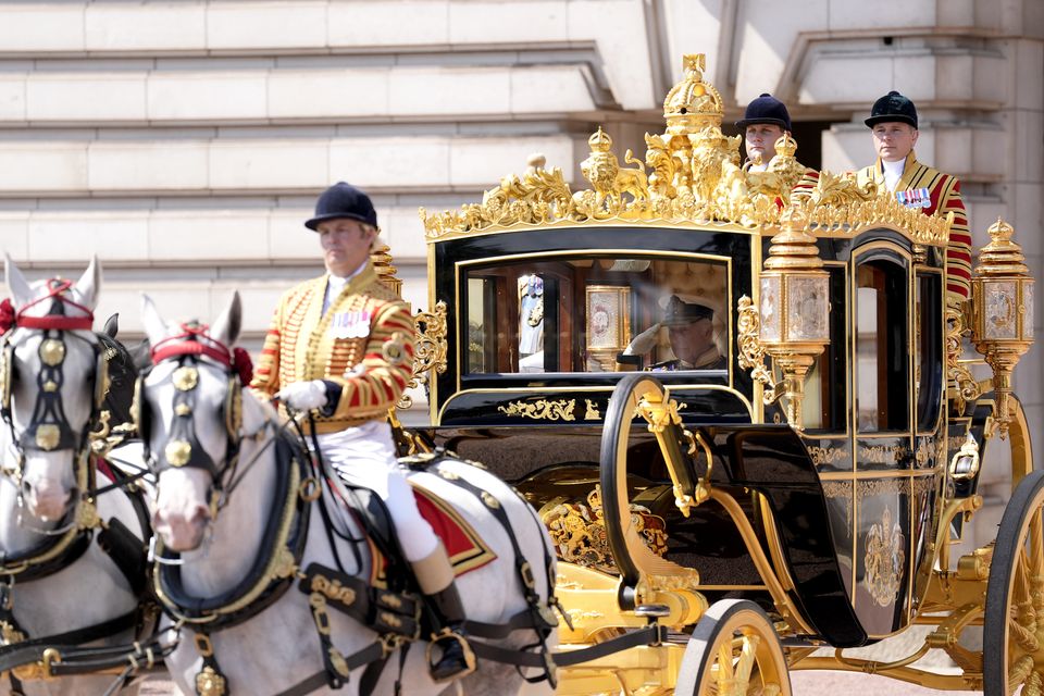 The King salutes the Life Guards as he and the Queen leave Buckingham Palace in the Diamond Jubilee State Coach to travel to the State Opening of Parliament (Andrew Matthews/PA)