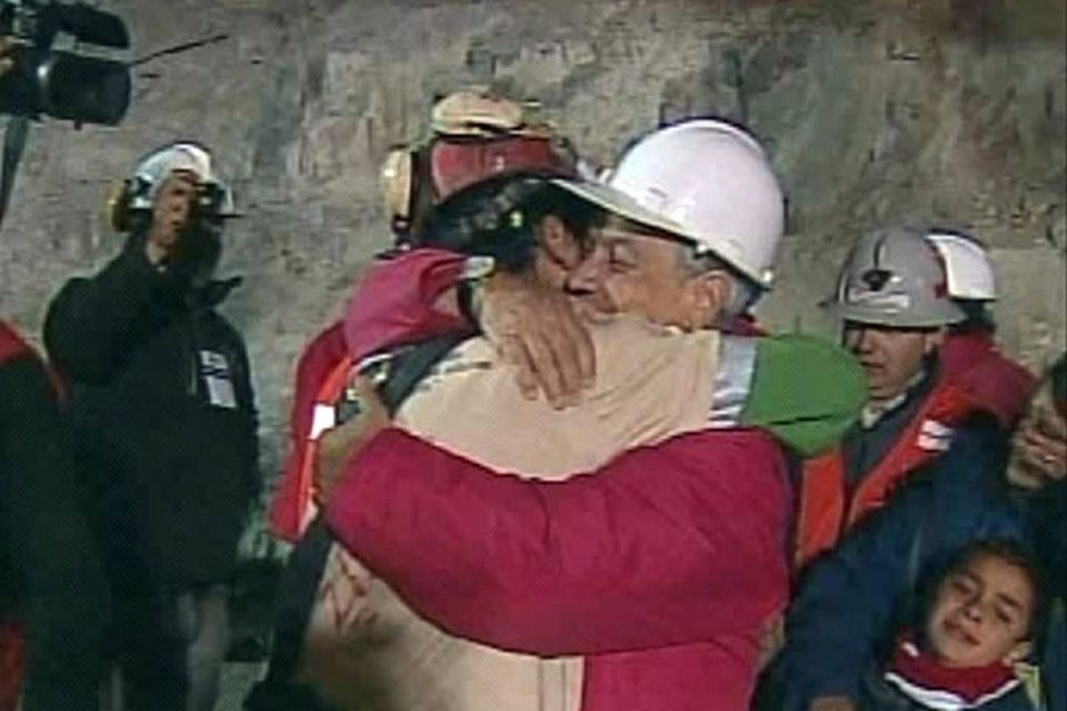 In this screen grab taken from video, Florencio Avalos, the first miner to be rescued, left, is embraced by Chilean President Sebastian Pinera after his rescue at San Jose Mine near Copiapo, Chile. (AP Photo)