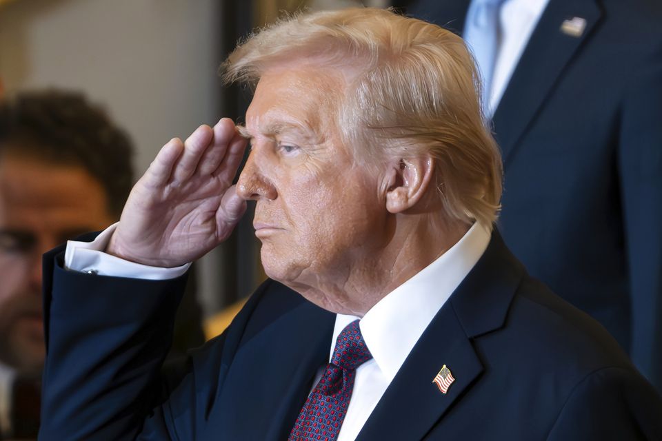 President Donald Trump salutes while on stage in Emancipation Hall at the 60th Presidential Inauguration (Ron Sachs/Pool Photo via AP)