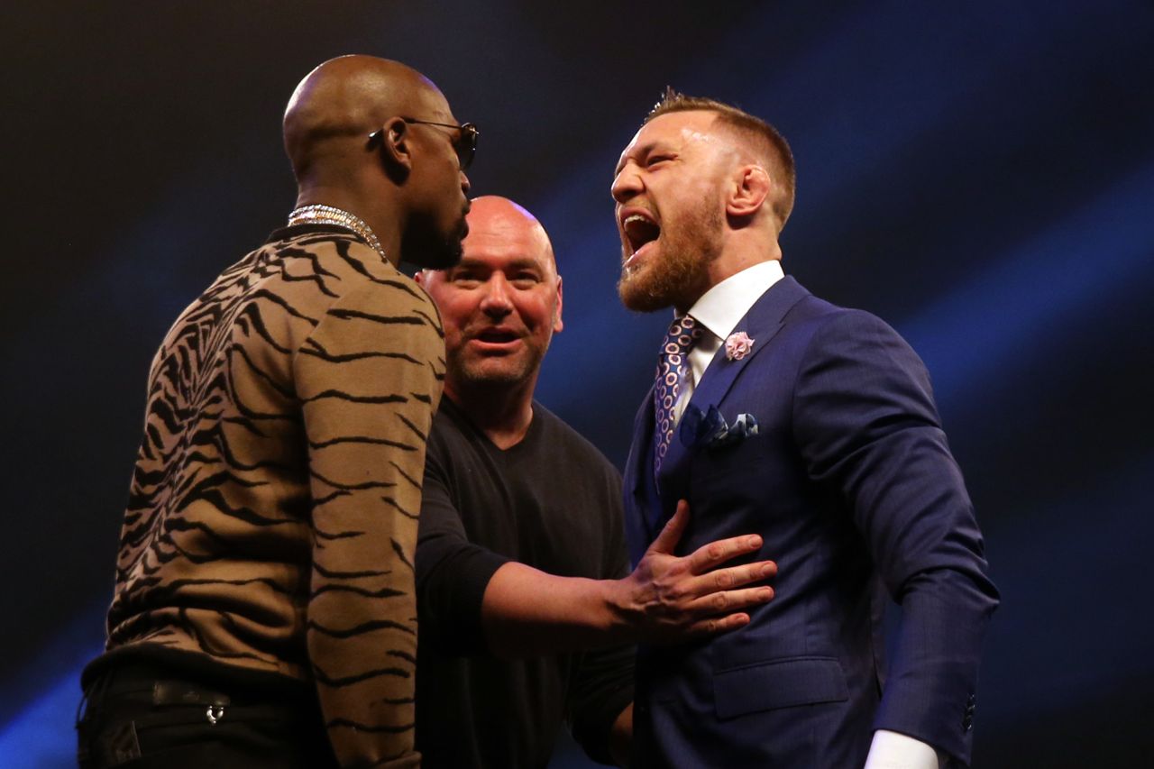 Floyd Mayweather forgets to dress up as he poses next to superstar